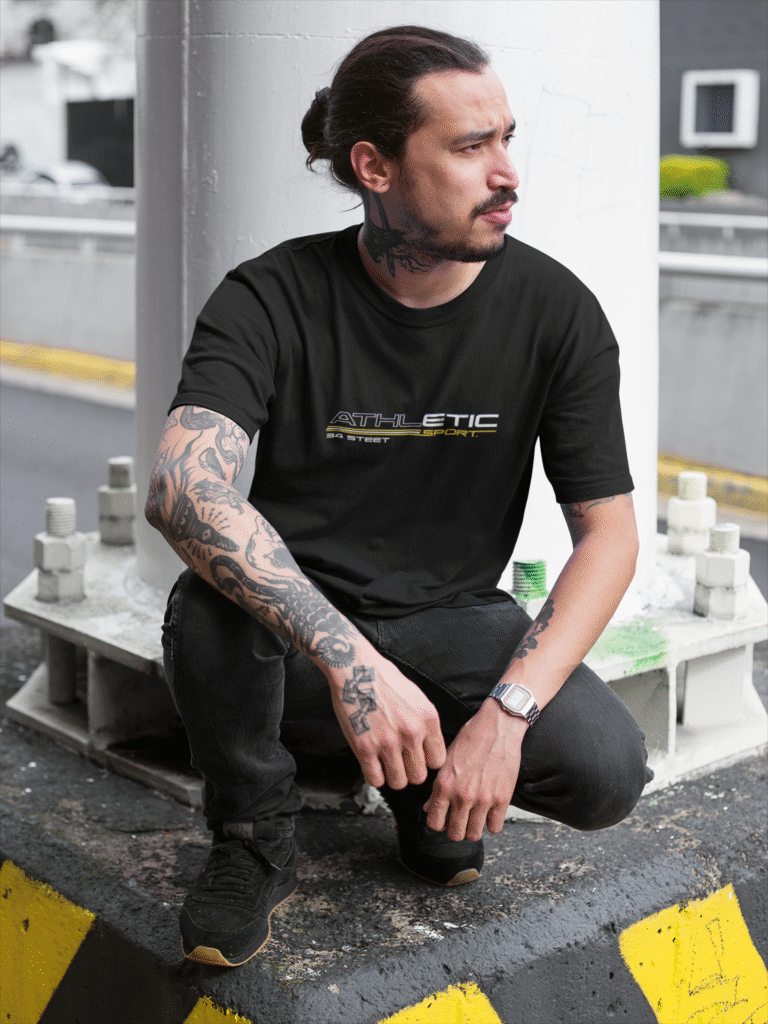 tattooed-man-wearing-a-round-neck-tee-mockup-while-crouching-under-a-bridge-a17078